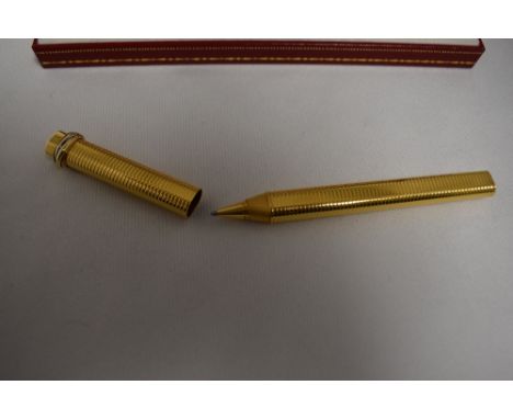 A Cartier Must de Cartier Trinity Vendome Oval Trinity ballpoint pen in a gold metal with tri-colour  banding on lid, oval sh