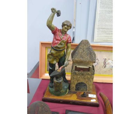 An Unusual Early XX Century 'Blacksmith' Table Lamp, with metal figure of a blacksmith at work hammering on an anvil next to 
