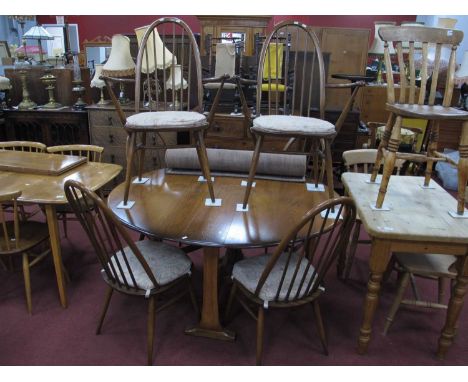 Ercol Dining Room Table and Chairs, table with a drop leaf oval top on shaped supports, together with six chairs (two arms, f