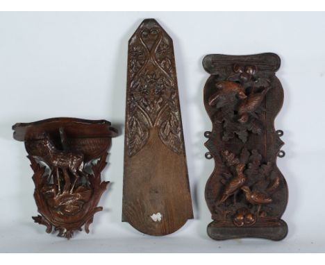 LATE 19th CENTURY BLACK FOREST CARBED SOFTWOOD EXPANDING BOOK RACK, the ends carved and pierced relief design of birds, ferns