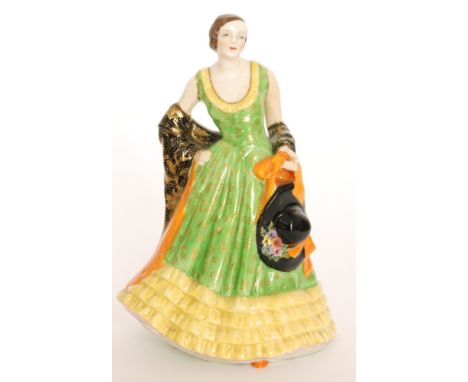 A 1930s Art Deco Plant Tuscan China model of a lady in Spanish dress holding a wide brimmed hat, printed mark, painted to the