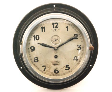A Third Reich era Kriegsmarine Bakelite wall clock with key, face marked Junghans (emblem erased but 'M' remaining), diameter