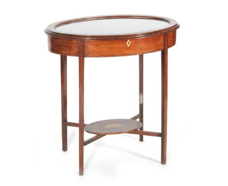 An early 20th Century vitrine or bijoiterie cabinet of oval form, with line inlaid detail and raised to tapered legs united b