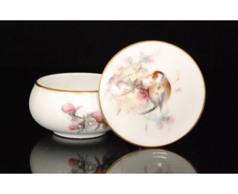 A Royal Worcester trinket pot and cover decorated with a hand painted goldfinch, puce mark with date code for 1914, diameter 