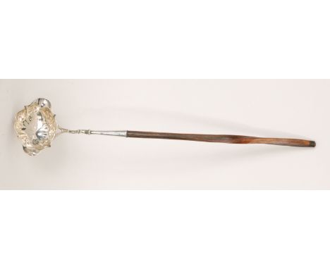 A George II hallmarked silver double lipped toddy ladle with ovoid bowl with scalloped rim and turned mahogany handle, length