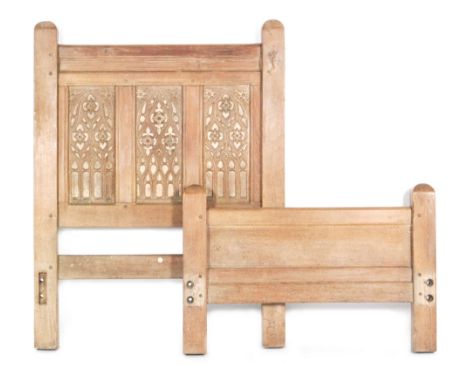 An Arts and Crafts pair of oak single bed ends by Heal and Son, with a carved triple fielded panel to the headboard and with 