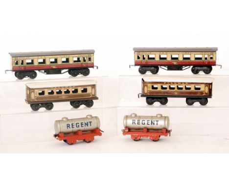 Two Marx O gauge corridor coaches in red and cream livery, two similar Mettoy pullman corridor coaches and two Chad Valley Re