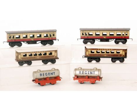 Two Marx O gauge corridor coaches in red and cream livery, two similar Mettoy pullman corridor coaches and two Chad Valley Re