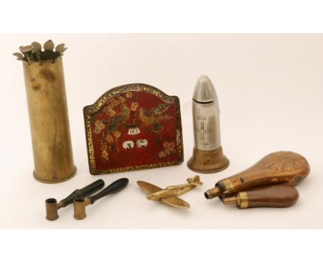 A small copper hunting horn, two copper powder flasks, two shot measures, a trench art shell, money box and brass Spitfire mo
