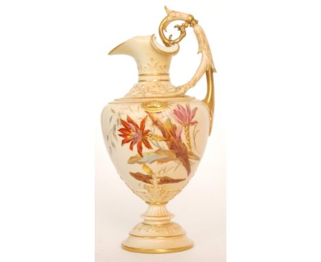 A late 19th Century Royal Worcester shape 1309 pedestal ewer decorated with gilt and enamel flowers against the blush ground,