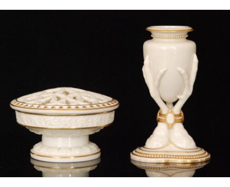 A late 19th Century Royal Worcester vase, supported by three bird claws bound by a ring with oval plaques, glazed white with 
