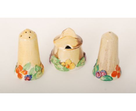 A 1930s Clarice Cliff My Garden cruet set of conical form with relief moulded floral bases picked out in orange, yellow and b