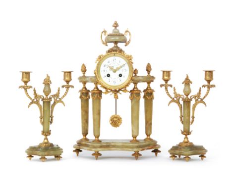 An early 20th Century French onyx and gilt metal clock garniture of pillared form, the dial signed A. La Renaissance, height 
