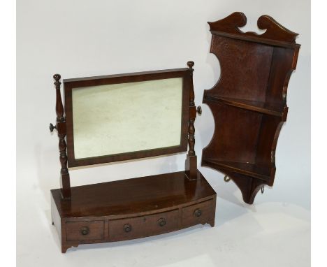 A George IV mahogany bow-fronted toilet swing mirror, fitted with three drawers to the base section above bracket feet, width