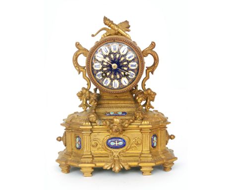 A 19th Century French gilt mantle clock, the case mounted with a flaming torch and a quiver above a circular blue enamelled d