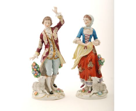 A pair of 20th Century Sitzendorf figures modelled as a young shepherd and shepherdess with floral encrusted decoration, prin