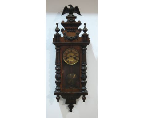 A late 19th Century walnut cased spring driven regulator wall clock mounted with an eagle pediment, height 91cm