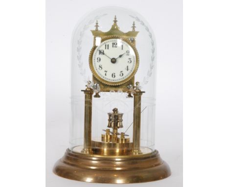 An early 20th Century 365 day brass mantle clock with circular Arabic dial in a glass dome, height 26cm.