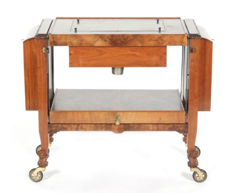 A mid 20th Century walnut veneered metamorphic drinks trolley, the lift-off top forming a serving tray and enclosing the cent