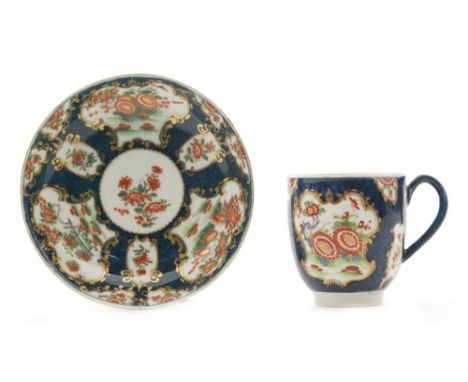 A late 18th Century Worcester coffee cup and saucer decorated with panels of Kakiemon style flowers against a blue fish scale