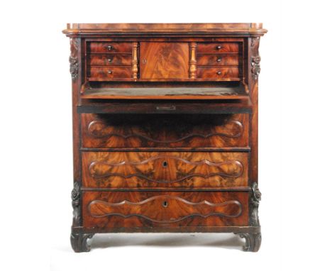 A 19th Century mahogany escritoire or secretaire a' abatant, with a moulded cushion frieze above the cartouche shaped panel f