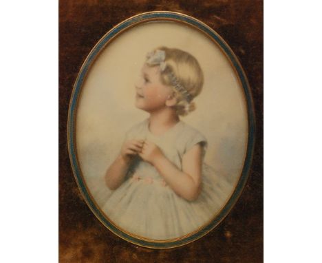 A hand tinted photographic miniature portrait on ivorine, circa 1940, depicting a little girl with ribbon in her hair, oval, 