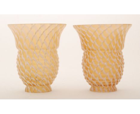 A pair of 20th Century French glass light shades of bell form in pale orange with white pulled trails, height 14cm.