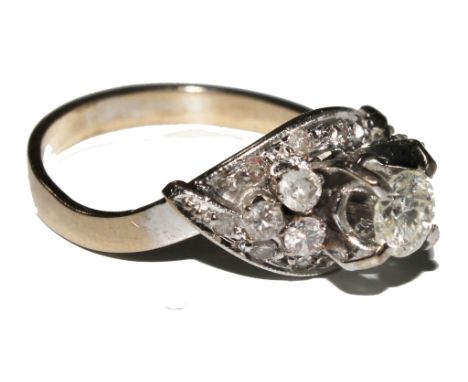 A fine diamond ring with a central diamond, three diamonds to each shoulder with a diamond set collar beneath £400-500