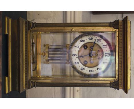 A 19th century French brass four glass two train mantle clock, movement striking on a bell, the white circular dial signed Ma