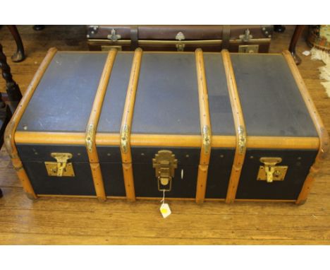 An early 20th century travel trunk with wood and brass mounts of oblong form with leather handles, 92cm wide £30-50