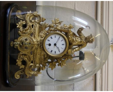 A 19th century French gilt mantle clock of circular form with Roman numerals, elaborate 'C' scroll and rococo carving with se