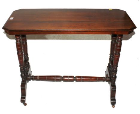 A late Victorian mahogany occasional or centre table with shaped top, raised on ring turned legs, stretcher and trestle suppo