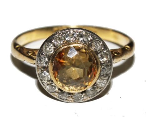 A cluster ring set with old-cut diamonds and a yellow stone to centre, possibly a yellow sapphire  £150-200