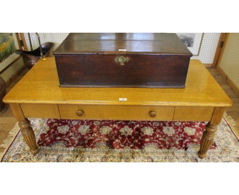 An early Victorian-style light oak occasional or coffee table of oblong form with shaped top, one drawer under with turned ha