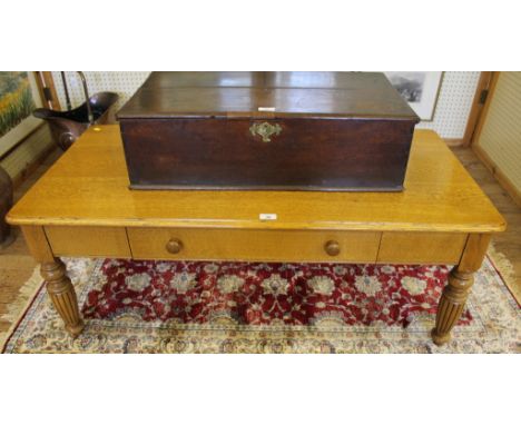 An early Victorian-style light oak occasional or coffee table of oblong form with shaped top, one drawer under with turned ha