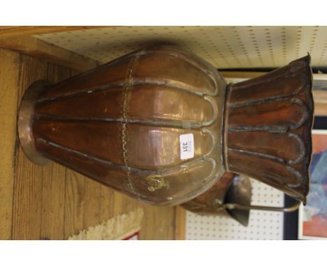 A late 19th century copper baluster shaped umbrella or stick stand with flared rim, fluted body on a circular base, 50cm high