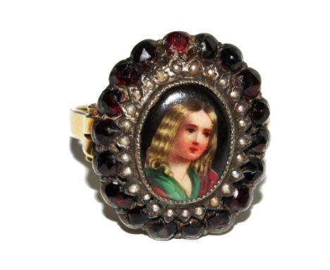 A cluster ring set with garnets and seed pearls with a porcelain plaque to centre of a young girl £80-120