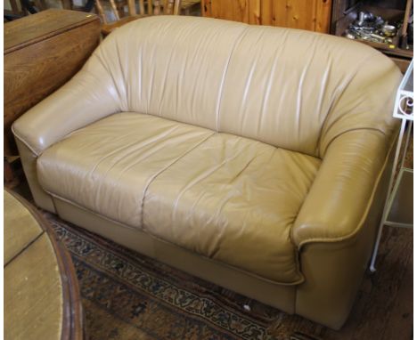 A contemporary light brown leather upholstered two-seat sofa with shaped arm rests, 145cm wide £100-150