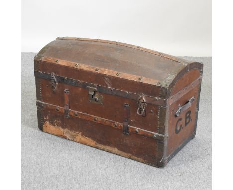 An early 20th century metal bound dome top trunk, painted with initials GB, 82cm
