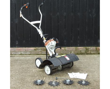 A Stihl petrol driven garden scarifier and aerator, together with accessories and manual