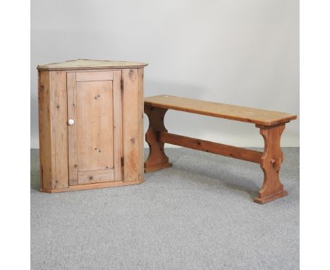 An antique pine corner cabinet, 72cm, together with a pine bench