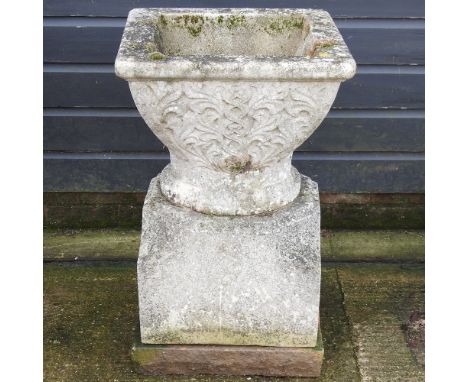 A large reconstituted stone garden pot, with celtic design, on a pedestal base, 80cm high overall