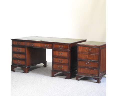 A reproduction pedestal desk, with a green inset top, on bracket feet, 152cm, together with a matching cabinet