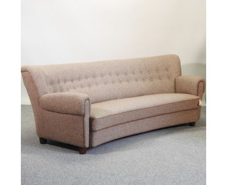 An Art Deco brown upholstered sofa, with a curved button back, 210cm