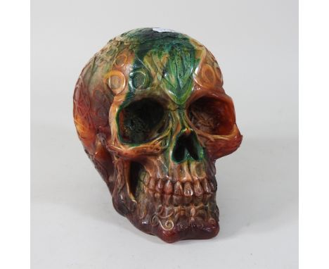 A modern carved coloured hardstone model of a skull, 14cm