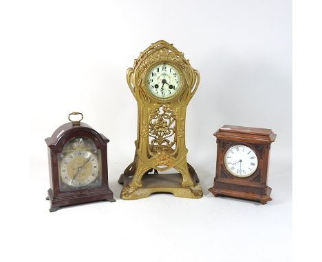An Art Nouveau gilt spelter cased mantel clock, with a white enamel dial, 42cm high, together with a 20th century Garrards ma