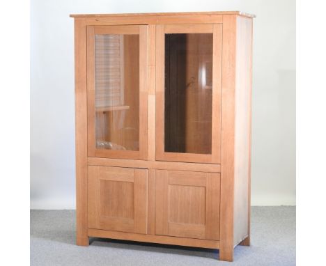 A light oak glazed cabinet, 127cm