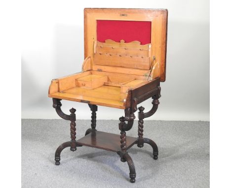 An unusual early 20th century light oak secretaire desk, with a hinged top and well fitted interior, on spirally turned suppo