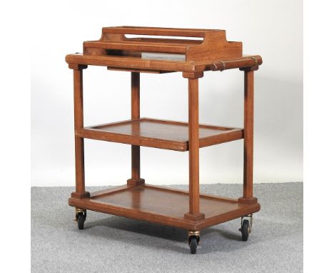 A 1920's light oak tea trolley, label S &amp; F Martell, 93cm