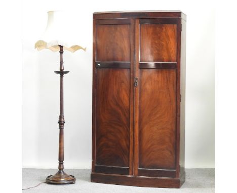 A 1930's bow front double wardrobe, 100cm, together with a turned wooden standard lamp and shade